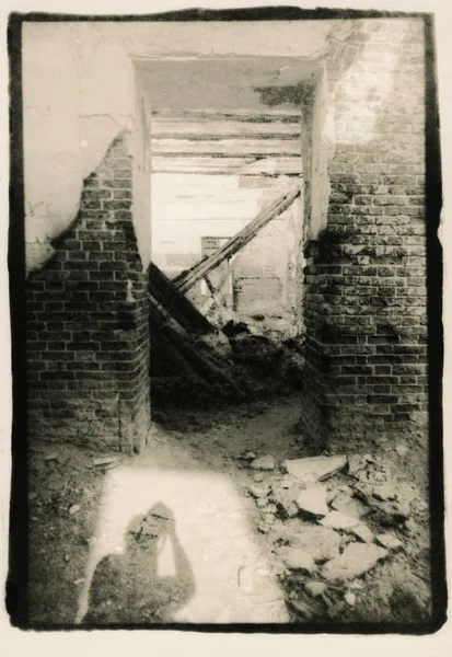 The shadow of the photographer who photographs the ruins.