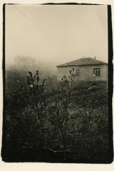 Rural house in the fog. Bakuriani.