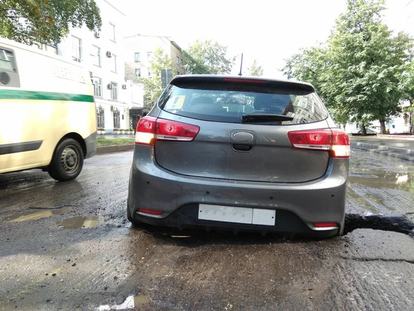 Araba arka tekerlekten yoldaki bir deliğe düştü..