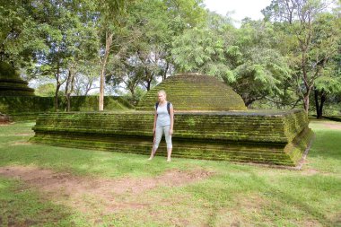 A traveler poses next to a large dome of an old building in Polo