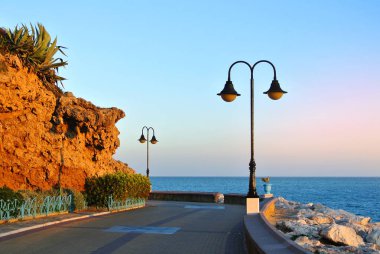 Torremolinos Promenade, bir yol, kaya, çiçek açan çalılar ve Akdeniz, Endülüs, İspanya.