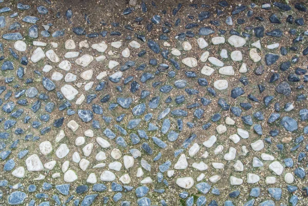 A pattern of little stones at a footpath in the park of Torremolinos, Andalusia, Spain. — Stock Photo, Image