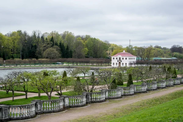 PETERHOF, RUSSIA - MAY 10, 2015: Lower gardens of Park of Peterhof, a view to a pond and a lonely house, St. Petersburg, Russia. Stock Picture