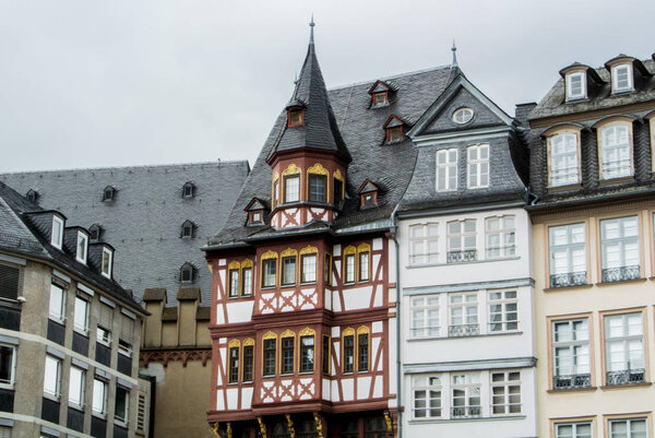FRANKFURT, GERMANY - JUNE 4, 2017: Traditional german decorated houses at the Frankfurt Old town square on cloudy rainy summer day.