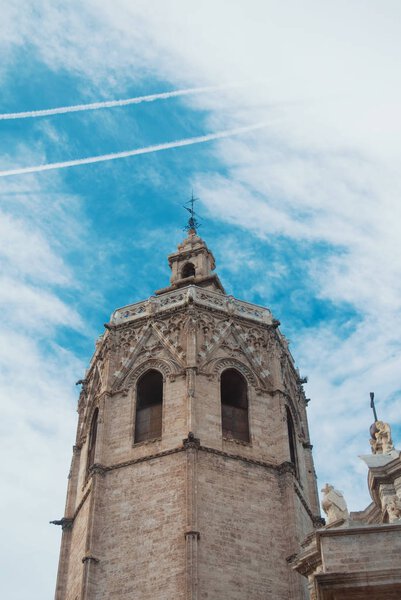 El Miguelete (El Micalet), the gothic bell tower of Valencia Cathedral in Spain and cloudy sky at the background.