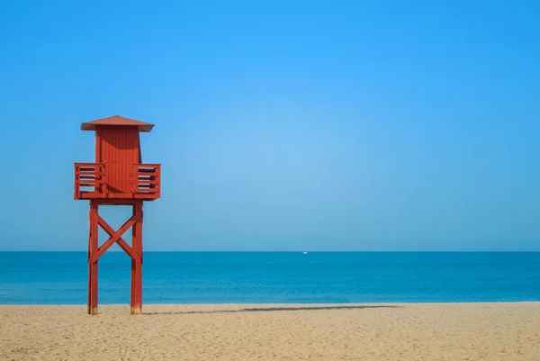 stock image Dark red wooden lifeguard tower on the abandoned beach at Benalm