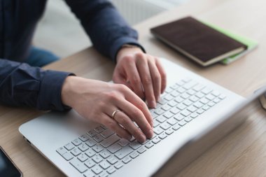 Tipik bir dizüstü bilgisayar klavye üzerinde eller. Onun işyerinde bir ofiste bir adam İnşaat