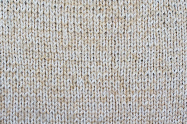 Background of beige textured draperies. Knitted pattern