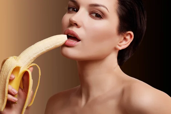 beautiful and sexy woman with a banana in her hand, contatsection, gradient