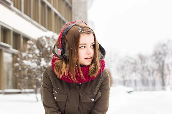 Girl listening to music in winter