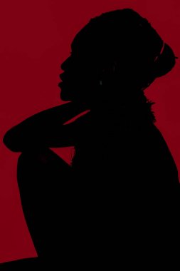 Dark skin model on the red background clipart