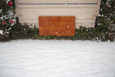 Noel ağacının arka planında kar var.