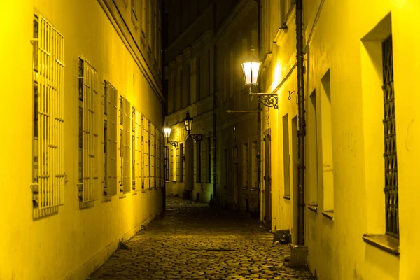 Narrow alleyway in the old district of the old town with glowing lights