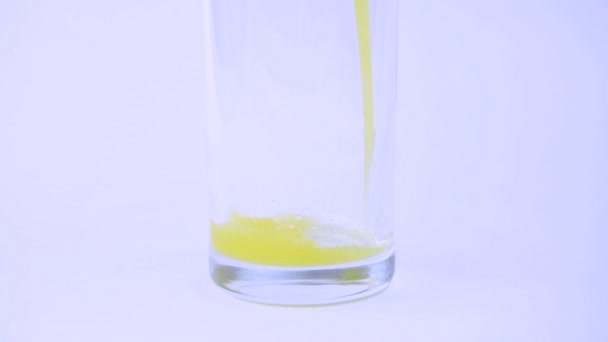 Slow Process Pouring Yellow Orange Transparent Glass White Background — Stock Video