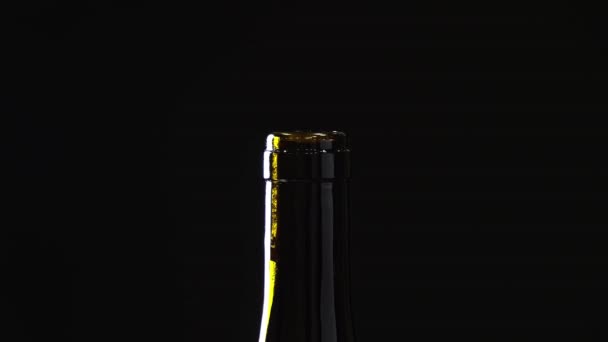 Close-up of the bottle neck. rotation of the bottles on dark background — Stock Video