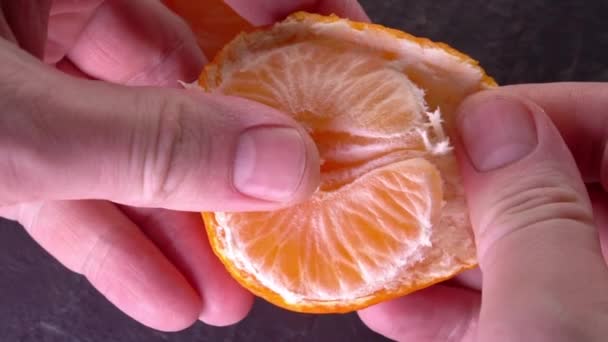 Slowmo tangerine. cleaning Mandarin close-up — Stock Video