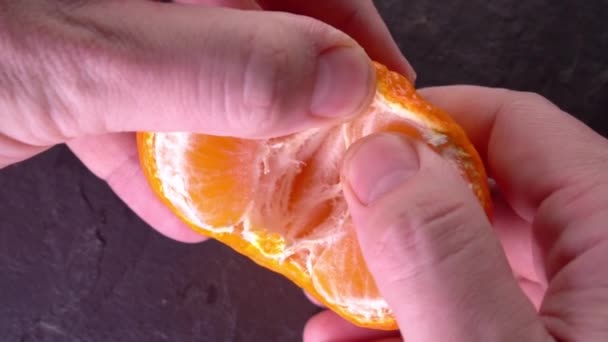 Slowmo tangerine. cleaning Mandarin close-up — Stock Video