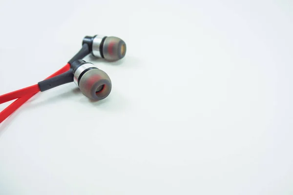 Червоні навушники лежать на білому тлі . — стокове фото