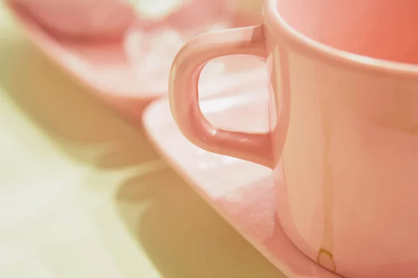 Coffee cup in pink colour close up.