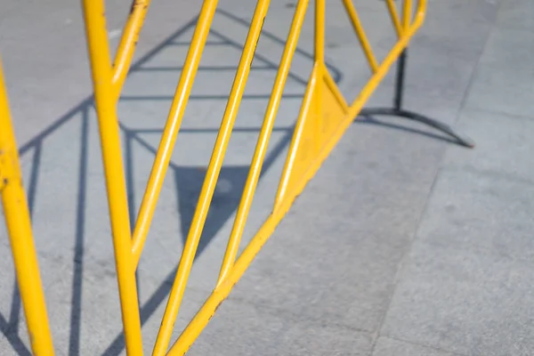Yellow fence in the parking lot at noon. — Stock Photo, Image