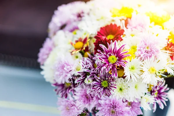Colorful flowers in a vase on the table.