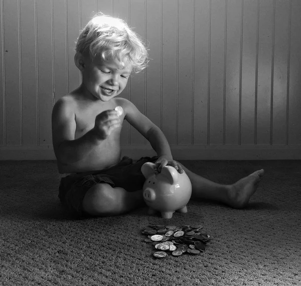 Boy playing with piggy bank — Stock Photo, Image