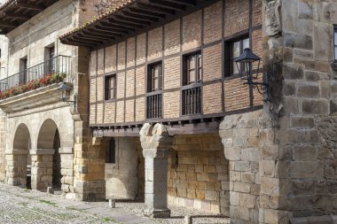 Village street, typical houses in touristic village of Santillana del Mar, province Santander, Cantabria, Spain clipart