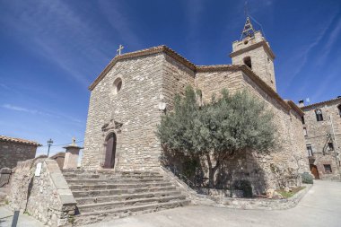 Village view, church of Santa Maria and Sant Joan, baroque style, Santa Maria Olo, moianes region comarca, province Barcelona, Catalonia. clipart
