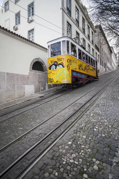 Rua íngreme com eléctrico amarelo típico em Lisboa . — Fotografia de Stock