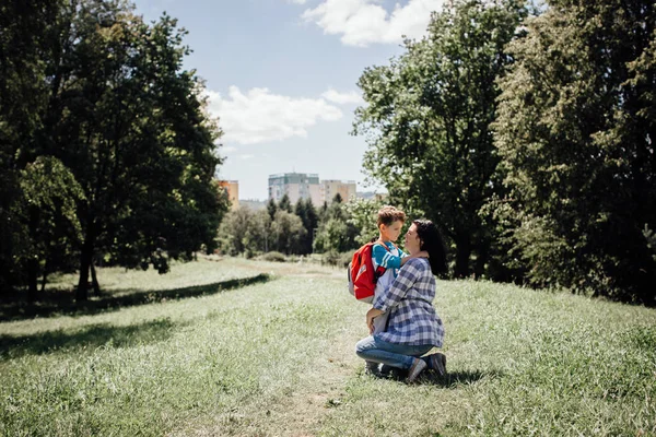 Moeder haar zoon knuffelen en afscheid van hem op weg naar school — Stockfoto