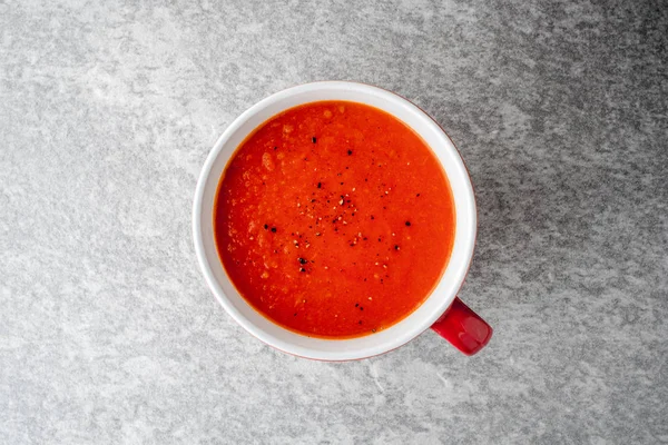 Tomato soup in ceramic bowl on stone background. — Stock Photo, Image