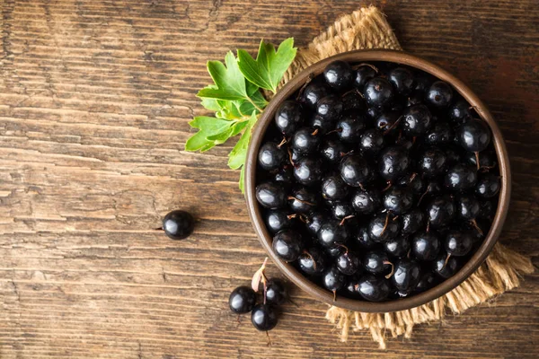 Seramik kase ahşap zemin üzerine altın kuş üzümü, taze çilek