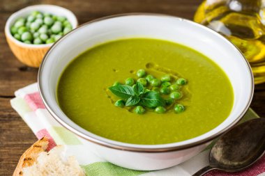 Yeşil bezelye çorbası kase ahşap tablo