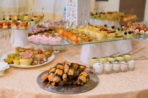 Skewers of meat and fish, delicatessen and buffet appetizers. A catering service. Restaurant, Banquet