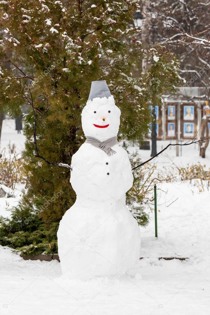 Snowman in the city Park. Winter holidays