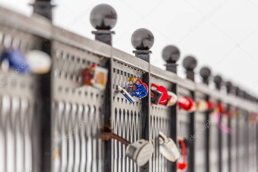 Locks of love and loyalty on the metal fence. The City Of Saratov, Russia. The Volga river embankment. Winter
