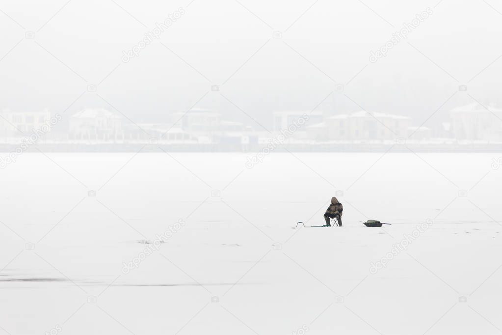 Winter fishing on the Volga river in Saratov. On the horizon is the city of Engels. Russia