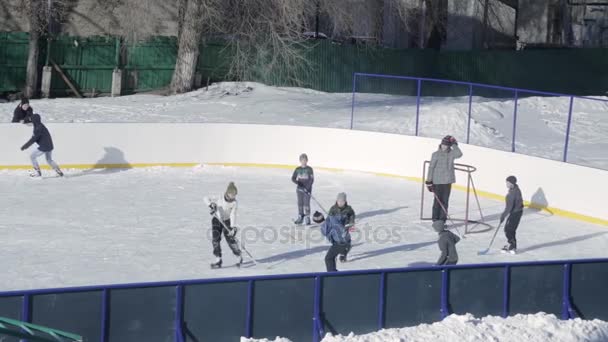 Chlapci hrají hokej na kluzišti na školním dvoře. Rusko, Saratov, 31 Jan 2017 — Stock video