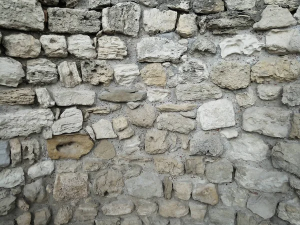 The stone texture. Wall of the ancient city. Historical excavations.