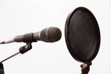 Cardioid condenser microphone and pop filter on a gray background. Home recording Studio. clipart