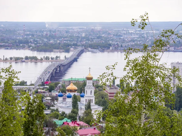 Ponte stradale sul fiume Volga tra le città di Saratov ed Engels. Lo skyline della città. Una Chiesa ortodossa. Maggio — Foto Stock