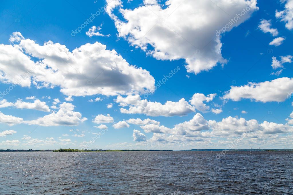 Summer river landscape. The Volga River, Saratov, Russia. Blue sky, white clouds