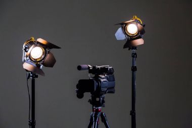 Camcorder and 2 spotlights with Fresnel lenses in the interior. Shooting an interview clipart