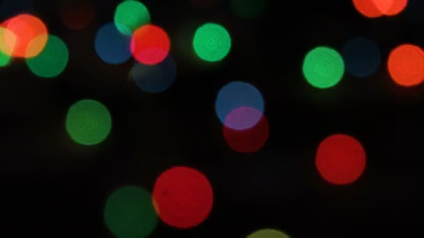 Flashing colored lights in a blur. The bokeh effect. Electric Christmas tree lights. Footage clip 4k — Stock Video