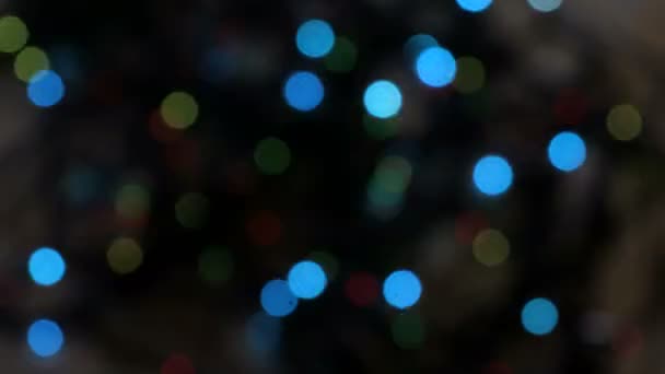 Flashing colored lights in a blur. The bokeh effect. Electric Christmas tree lights. Footage clip 4k — Stock Video