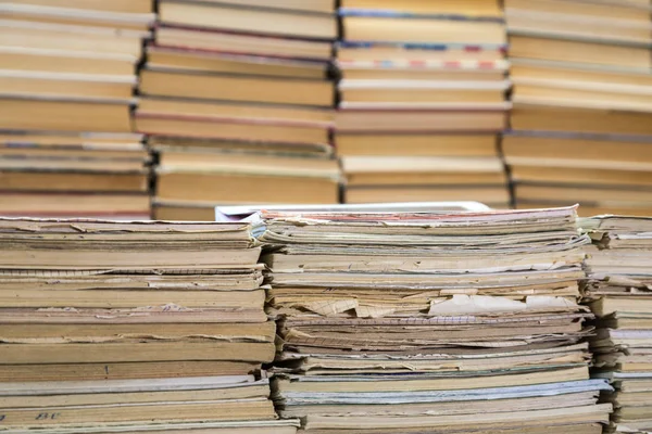 A stack of old school notebooks and a stack of textbooks or books — Stock Photo, Image