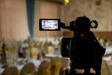 Filming of the event. Videography. Served tables in the Banquet hall. clipart