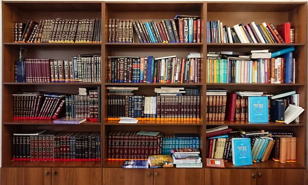 Saratov / Russia - February 25, 2018: Library in the synagogue. Multi-colored books on the bookshelf in the library