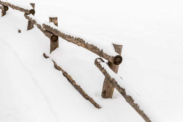 Деревянный забор в снегу. Зимний день в городском парке
.