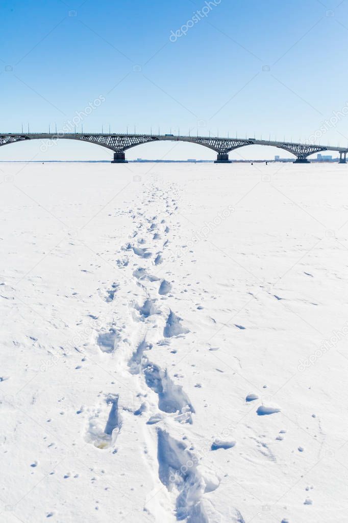 Road bridge across the Volga river between the cities of Saratov and Engels. Winter day. Ice on the river